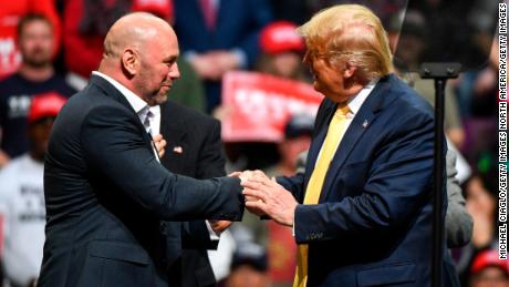 White greets President Donald Trump on stage during a Keep America Great rally in Colorado Springs.