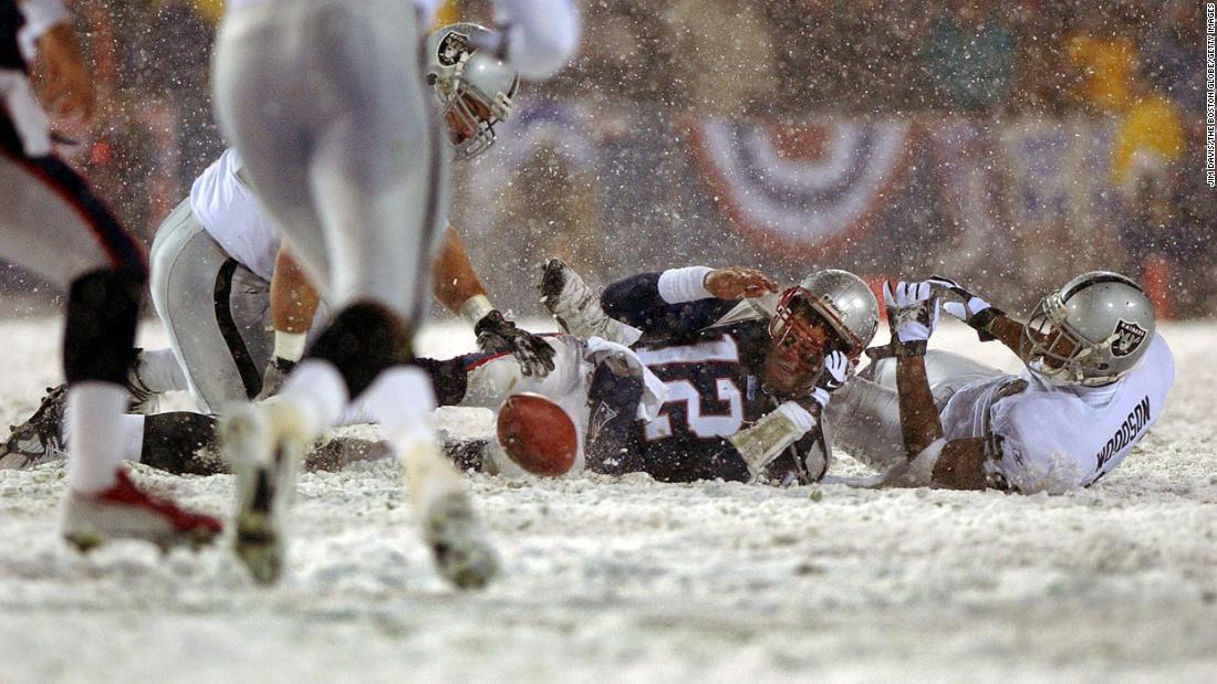 Brady loses the ball after being hit by Oakland&#39;s Charles Woodson during an NFL playoff game in January 2002. The Patriots got the ball back and went on to win the game, but the controversial play was heavily debated in the offseason. The &quot;tuck rule&quot; was eventually repealed in 2013.