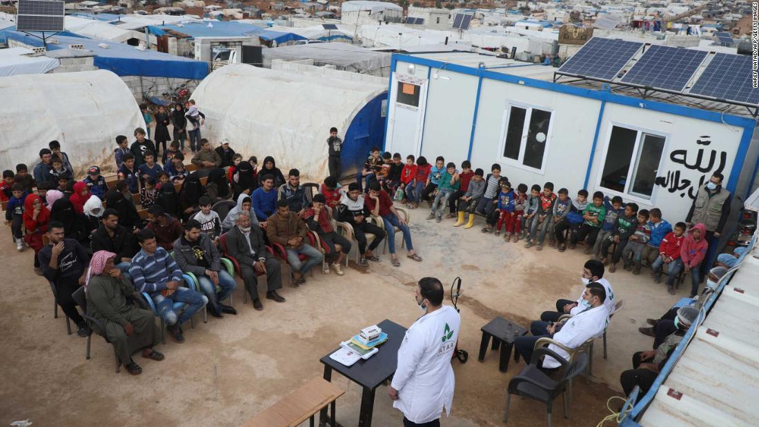 Displaced families near Atme, Syria, attend a workshop aimed at spreading awareness about the coronavirus.
