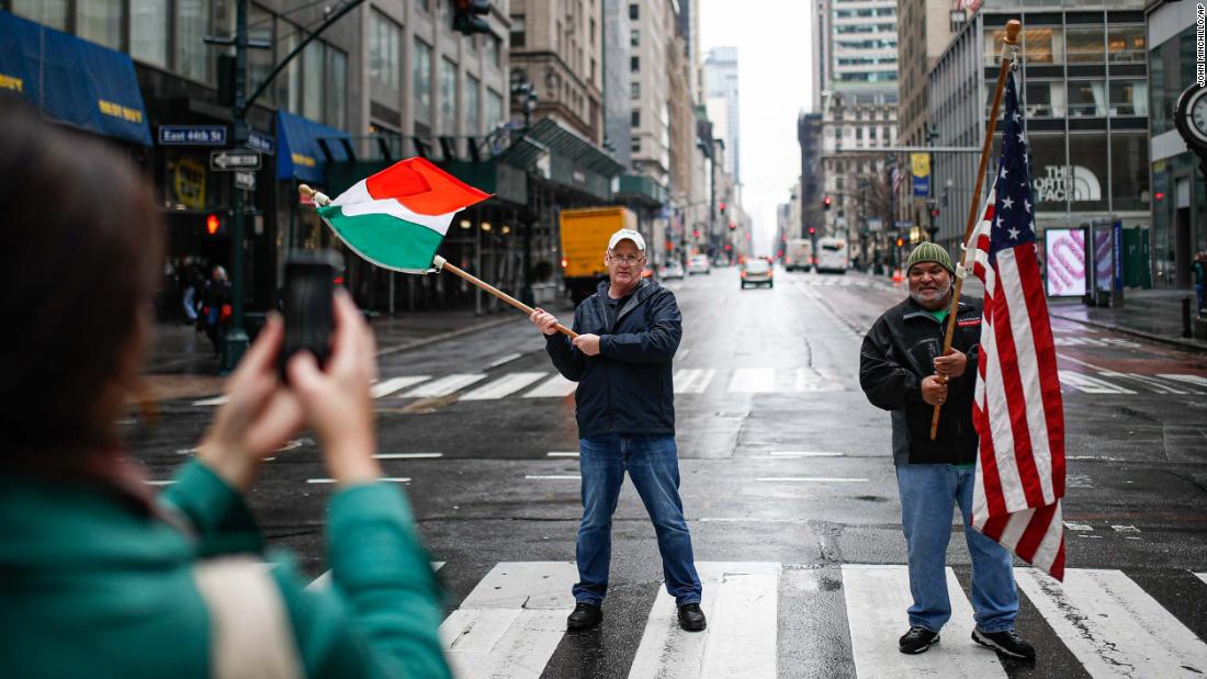 Dermot Hickey, left, and Phillip Vega ask a pedestrian in New York to take their picture on a thinly trafficked Fifth Avenue on March 17. Many streets across the world are much more bare as people distance themselves from others. In the United States, the White House has advised people &lt;a href=&quot;https://www.cnn.com/2020/03/16/politics/white-house-guidelines-coronavirus/index.html&quot; target=&quot;_blank&quot;&gt;not to gather in groups of more than 10.&lt;/a&gt;