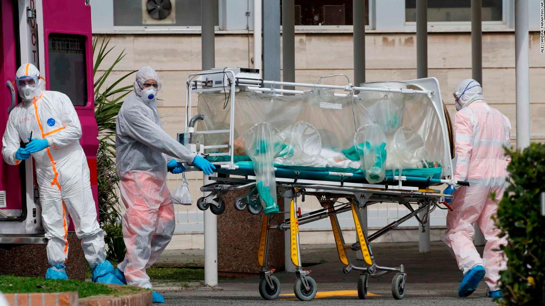 A patient in a biocontainment unit is carried on a stretcher in Rome on March 17, 2020.