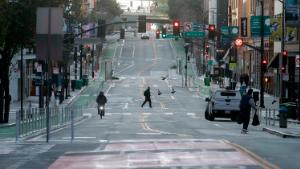 A man crosses a nearly empty street in San Francisco, Tuesday, March 17, 2020. Officials in seven San Francisco Bay Area counties have issued a shelter-in-place mandate affecting about 7 million people, including the city of San Francisco itself. The order says residents must stay inside and venture out only for necessities for three weeks starting Tuesday. (AP Photo/Jeff Chiu)