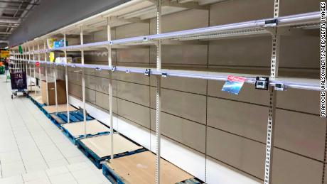 TOPSHOT - This picture taken on March 14, 2020, shows empty stalls in a supermarket in Brussels, during the COVID-19 outbreak caused by the novel coronavirus. - Belgium close schools, cancel all cultural events and shutter bars and restaurants to stave off the spread of the coronavirus outbreak.  Beginning on March 14, only stores that provide essential services, such as pharmacies and grocery stores, will remain open under normal conditions. (Photo by François WALSCHAERTS / AFP) (Photo by FRANCOIS WALSCHAERTS/AFP via Getty Images)