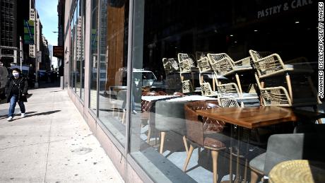 Chairs are stacked in a closed Cafe in Manhattan on March 16, 2020 in New York City. - Stocks tumbled on March 16, 2020 despite emergency central bank measures to prop up the virus-battered global economy, as countries across Europe started the week in lockdown and major US cities shut bars and restaurants. The virus has upended society around the planet, with governments imposing restrictions rarely seen outside wartime, including the closing of borders, home quarantine orders and the scrapping of public events including major sporting fixtures. (Photo by Johannes Eisele/AFP/Getty Images)