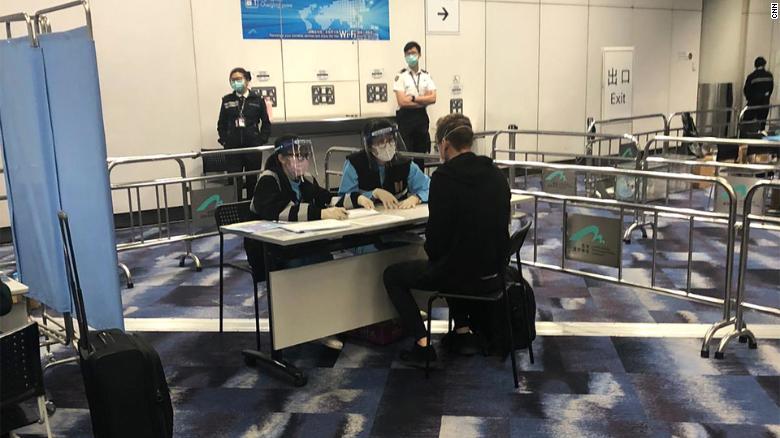 Quarantine officers interview Will Ripley on arrival at Hong Kong International Airport on March 15. 