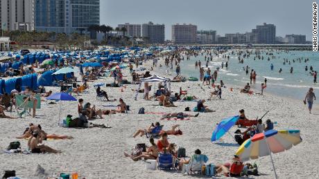 Visitors enjoy Clearwater Beach, Wednesday, March 18, 2020, in Clearwater Beach, Fla. Beachgoers are trying to keep a safe distance from each other by keeping a space of 6 to 10 feet (2 to 3 meters) between family groups to help protect from the spread of the coronavirus. (AP Photo/Chris O&#39;Meara)