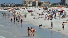 Visitors enjoy Clearwater Beach, Wednesday, March 18, 2020, in Clearwater Beach, Fla. Beach goers are keeping a safe distance from each other to help protect from the spread of the Coronavirus. (AP Photo/Chris O'Meara)