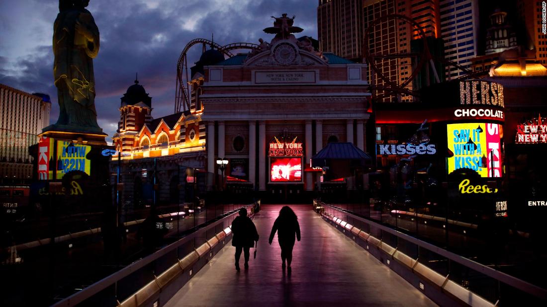 People walk along the Las Vegas Strip on March 18 after casinos were ordered to shut down.