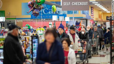 Shoppers wait in the checkout line at a Stop &amp; Shop supermarket on Thursday, March 19, 2020, in North Providence, Rhode Island. 