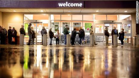 Shoppers wait in line to enter a Stop &amp; Shop supermarket in North Providence, RI