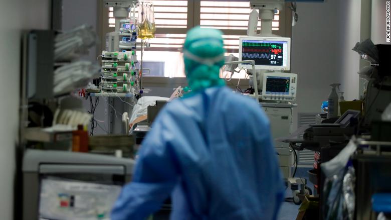 A doctor watches a coronavirus patient in the intensive care unit of Brescia hospital, Italy.