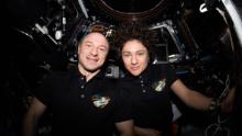 NASA astronauts Andrew Morgan and Jessica Meir pose for a portrait inside the cupola, the International Space Station&#39;s &quot;window to the world.&quot; The two Expedition 62 Flight Engineers were participating in the capture activities of Northrop Grumman&#39;s Cygnus cargo craft.