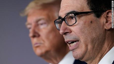 WASHINGTON, DC - MARCH 17: Treasury Secretary Steven Mnuchin (R) speaks while flanked by U.S. President Donald Trump during a briefing about the coronavirus in the press briefing room at the White House on March 17, 2020 in Washington, DC. The Trump administration is considering an $850 billion stimulus package to counter the economic fallout as the coronavirus spreads. (Photo by Drew Angerer/Getty Images)