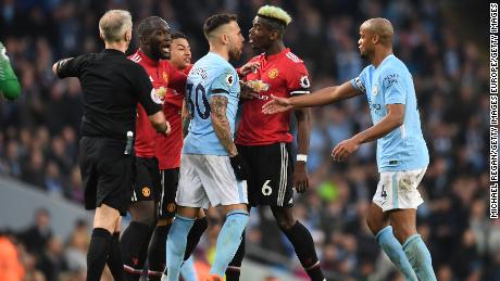 Manchester United and Manchester City players clash during their Premier League match.