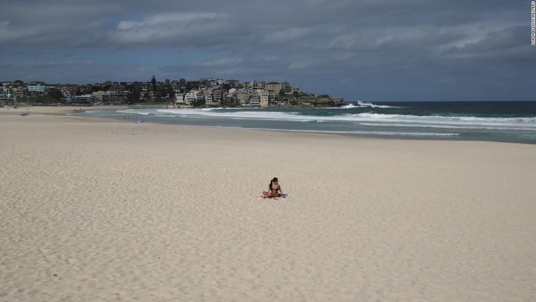A single sunbather remains following the closure of Sydney&#39;s Bondi Beach on March 21.