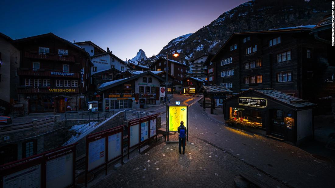 A pedestrian looks at a map at the Zermatt ski resort in Switzerland on March 18.