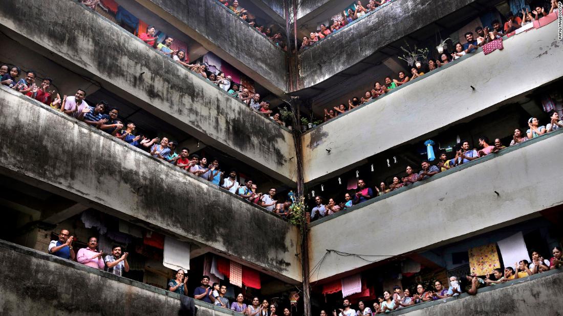 People clap from balconies to show their appreciation for health care workers in Mumbai, India.
