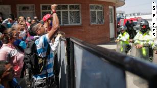 Relatives of inmates gather outside La Modelo jail in Bogota, Colombia, Sunday, March 22, 2020. 