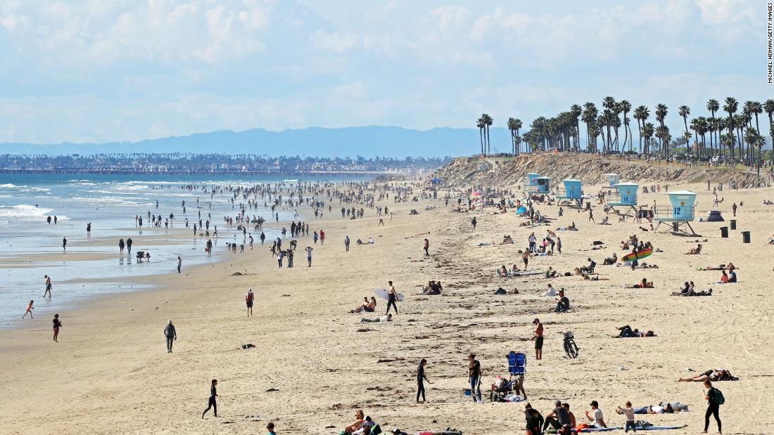 People are seen on California&#39;s Huntington Beach on March 21, 2020. Crowds descended on California beaches, hiking trails and parks over the weekend &lt;a href=&quot;https://www.cnn.com/2020/03/23/us/california-stay-at-home-beach-goers/index.html&quot; target=&quot;_blank&quot;&gt;in open defiance of a state order&lt;/a&gt; to shelter in place and avoid close contact with others.