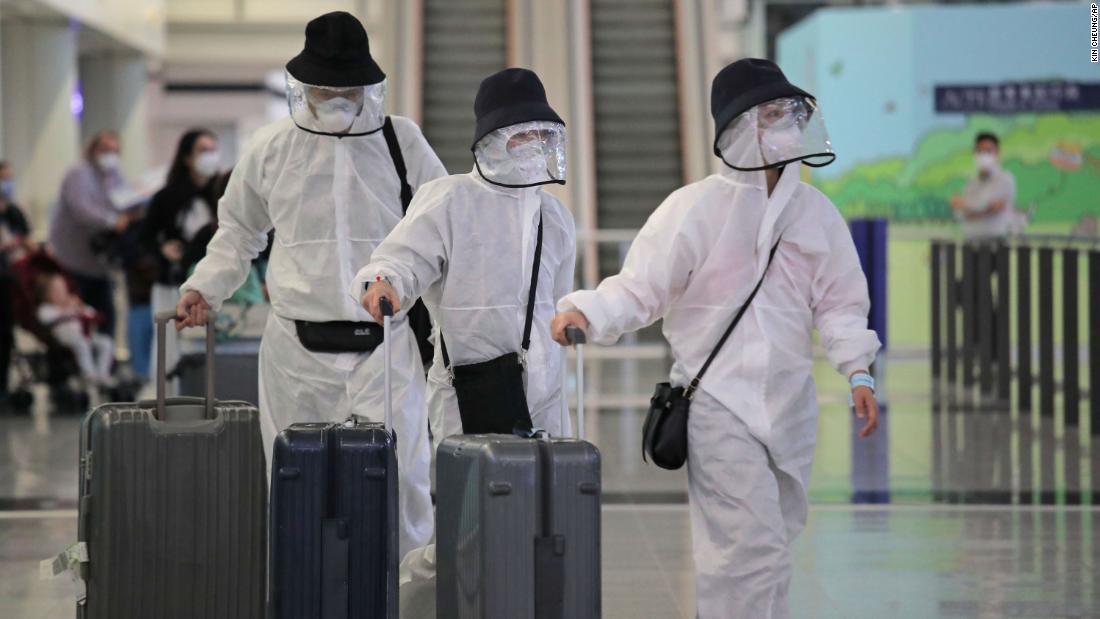 Passengers arrive at Hong Kong International Airport on March 23, 2020.
