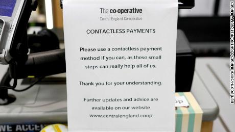 A sign urging customers to use &#39;contactless payments&#39; at a Co-Operative Store amid Coronavirus fears in Derby, United Kingdom.