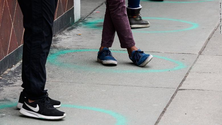 People stand in freshly painted circles, six-feet-apart, as they wait in a two-hour line on March 23, 2020 in Denver, Colorado.