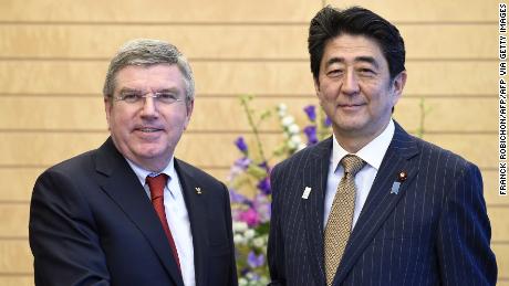 International Olympic Committee (IOC) President Thomas Bach (L) and Japanese Prime Minister Shinzo Abe shake hands prior to their meeting at Abe&#39;s official residence in Tokyo on March 13, 2015. 
