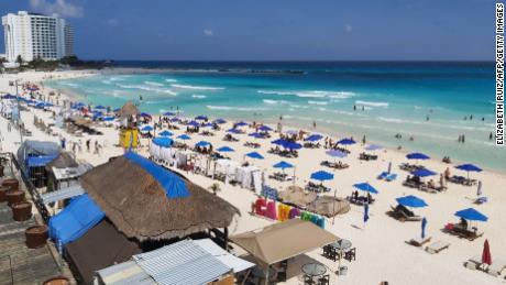 People enjoy a day at the beach in Cancun, Mexico, over the weekend, despite the coronavirus pandemic.