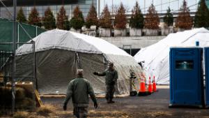 NEW YORK, NY - MARCH 25: Workers and Military Members build a makeshift morgue outside of Bellevue Hospital on March 25, 2020 in New York City, New York. Across the country schools, businesses and places of work have either been shut down or are restricting hours of operation as health officials try to slow the spread of COVID-19. (Photo by Eduardo Munoz Alvarez/Getty Images)