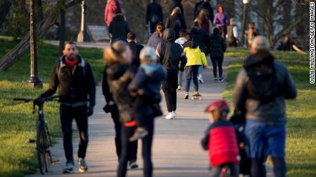 People walking through Primrose Hill on March 25 in London as UK Prime Minister Boris Johnson urged people to stay at home.
