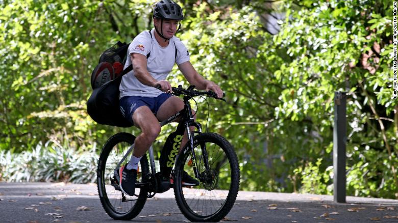 New Zealand rugby player Beauden Barrett arrives on his bike for kicking training in isolation.