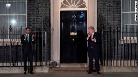 Boris Johnson, right, taking part in a national applause with his chancellor, Rishi Sunak.