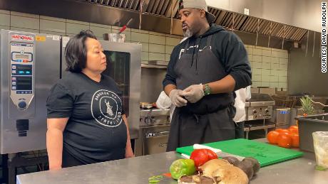 Genevieve Vang of Bangkok 96 Street Food and Maxcel Hardy of Coop Caribbean Fusion discuss plans for the day&#39;s menu.