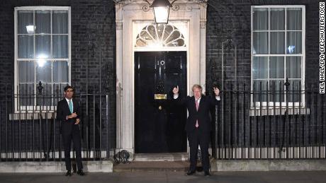 Boris Johnson, right, standing at a distance from his finance minister, Rishi Sunak, on Thursday evening.