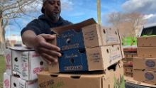Chef Maxcel Hardy moves boxes of perishable foods donated to the initiative.