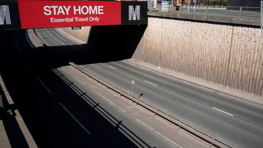 A screen advises motorists to stay home in Manchester, England.