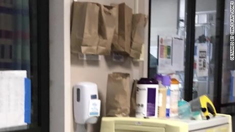 One Louisiana hospital is using brown paper bags by the ICU doors to store used masks 