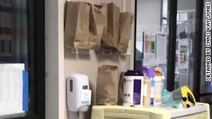 One Louisiana hospital is using brown paper bags by the ICU doors to store used masks 