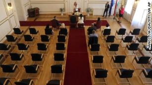 Groom Gyorgy David Jablonovszky and his bride Timea Jablonovszky sit, along with close relatives, during their wedding ceremony on Saturday, March 28, at the town hall in Miskolc, Hungary.