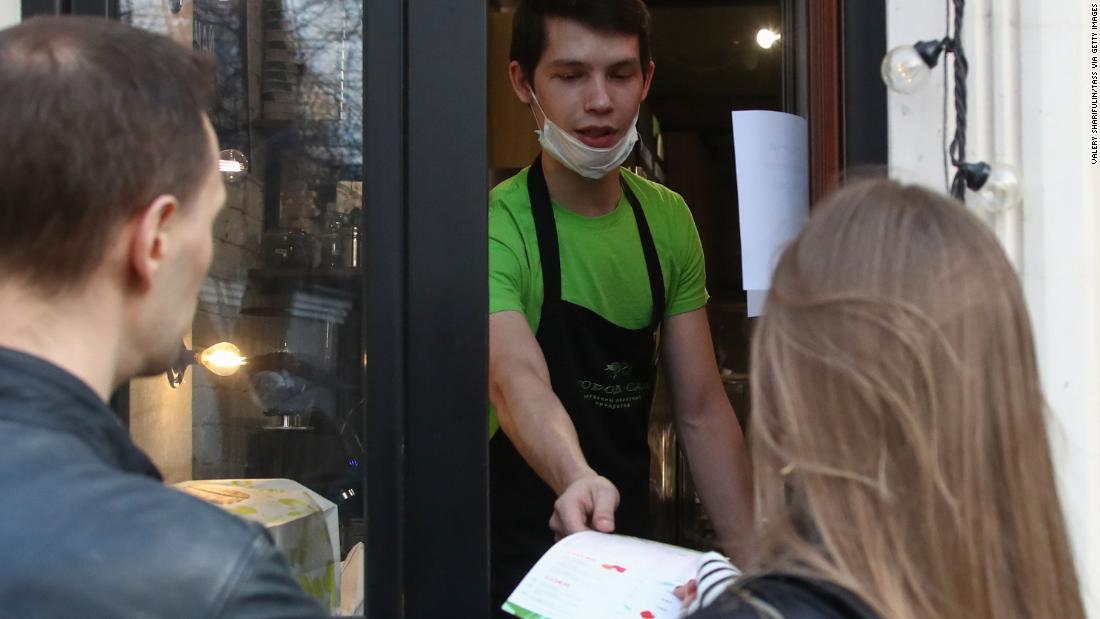 A waiter serves takeout in Moscow on March 28,