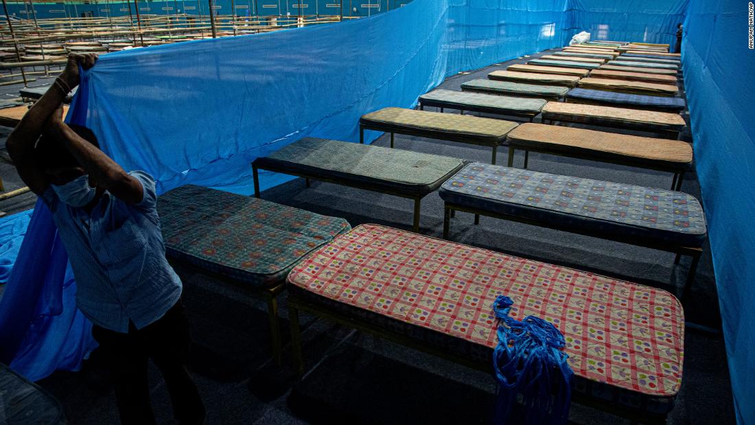 A worker fixes partitions at a quarantine center in Guwahati, India, on March 28, 2020.