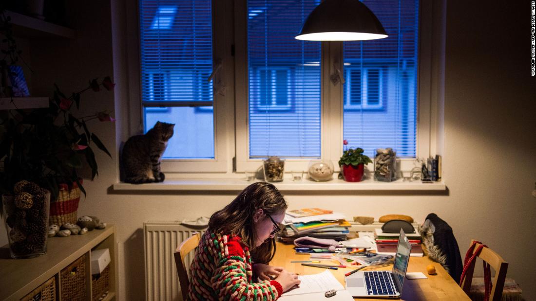 A student does homework in Bratislava, Slovakia, on March 27, 2020. Schools were shut down across the world, and many children have been receiving their lessons online.