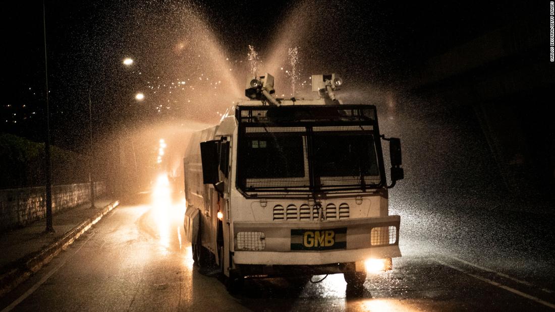 A National Guard truck sprays disinfectant in Caracas, Venezuela, on March 27, 2020.