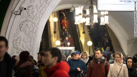 In this photo taken on  Feb. 22, a surveillance camera, top left, is seen as people walk down in a Moscow&#39;s Metro. 