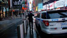 A NYPD officer patrols Times Square as rain falls on March 28, 2020 in New York City. - US President Donald Trump said on March 28, 2020 that he&#39;s considering a short-term quarantine of New York state, New Jersey, and parts of Connecticut. (Photo by Kena Betancur / AFP) (Photo by KENA BETANCUR/AFP via Getty Images)