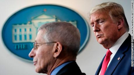 President Trump listens to Dr. Anthony Fauci speak during a briefing on the coronavirus pandemic at the White House on March 24.