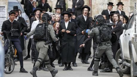 Israeli security forces arrest an ultra-Orthodox Jewish man as they close a synagogue in Jerusalem on Monday.