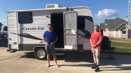 Dr. Jason Phillips (left) and Dr. Craig Reese Brockman with a donated camper that Brockman will use to prevent the risk of passing along the coronavirus to his family. 