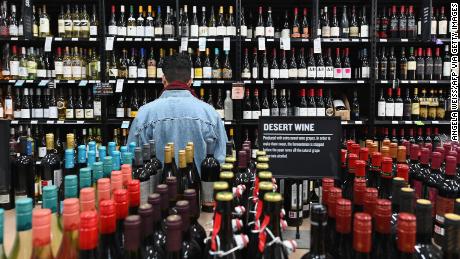 A patron stands in front of a shelf full of wine bottles at The Liquor Store.Com on March 20, 2020 in the Brooklyn borough of New York. - Liquor sales have exploded in New York since a national emergency was declared and New York closed all its theatres, bars and restaurants, while virtual cocktail parties with &quot;quarantinis&quot; are on the rise. (Photo by Angela Weiss / AFP) (Photo by ANGELA WEISS/AFP via Getty Images)