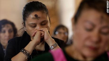 Women listen on Ash Wednesday at St. Mary&#39;s Cathedral in San Francisco on February 26, 2020. 